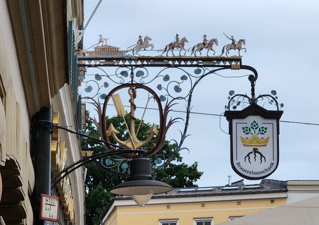 Sign with ornate iron work on a building in Germany.