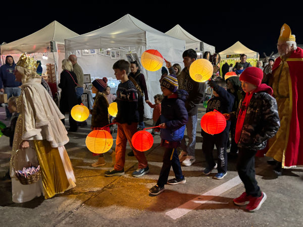 Children carry lanterns strolling through the market